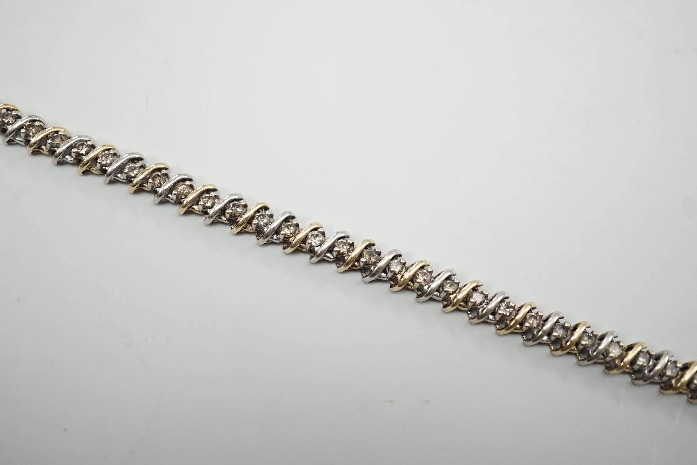 A modern two colour 14k and diamond chip set bracelet, 18.5cm, gross weight 12.7 grams.